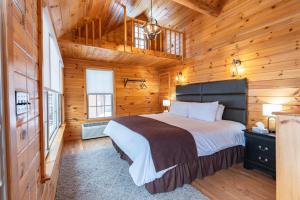 a bedroom with a bed in a wooden cabin at Presidential Mountain Resort in Bethlehem
