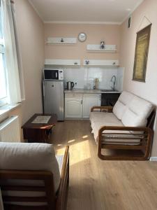 a living room with a couch and a kitchen at Miga's guest house & tour in Ulaanbaatar +8 photos