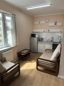 a small room with two beds and a kitchen at Miga's guest house & tour in Ulaanbaatar