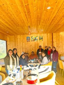 a group of people sitting at a table in a restaurant at Canvas stay by Fairlink in Jāmb