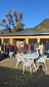 a group of people standing in front of a building at Canvas stay by Fairlink in Jāmb +4 photos