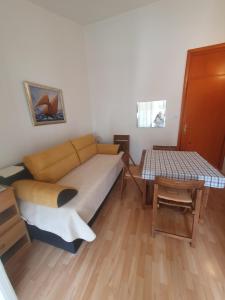 a living room with a couch and a table at Marica Dedić in Barbat na Rabu