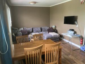 a living room with a table and a couch at Magsjön in Surahammar