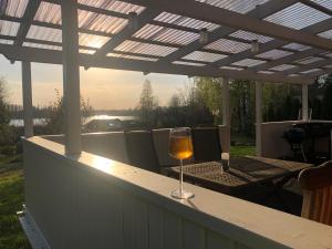 a glass of wine sitting on a table on a patio at Magsjön in Surahammar