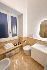 a bathroom with a toilet and a sink and a tub at Sorrento Downtown in Sorrento +16 photos