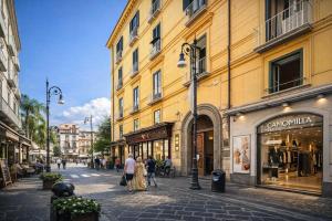 a city street with people walking down a street at Sorrento Downtown in Sorrento