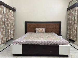 a bedroom with a bed in a room with curtains at Dj's home stay in Jodhpur