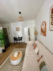 a living room with a couch and a table at Votre cocon parisien in Bagnolet +9 photos