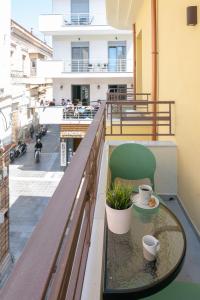 a balcony with a table and two cups on it at Aplo Chios Deluxe Apartments in Chios
