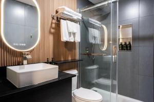 a bathroom with a sink and a toilet and a shower at The Tide's Out in Parksville