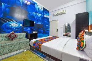 a hotel room with a bed and a couch at DG Hotel Green Vista in Jaipur
