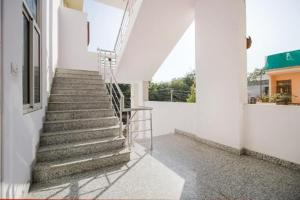 a stairway in a white building with a ladder at DG Hotel Green Vista in Jaipur
