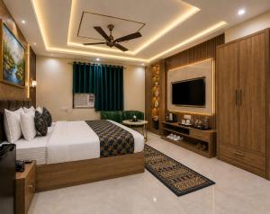 a hotel room with a bed and a flat screen tv at Hotel GRAN-SOL Near DELHI Airport in New Delhi