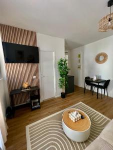 a living room with a couch and a table at Votre cocon parisien in Bagnolet