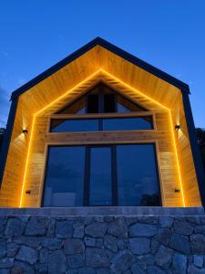 a house with a triangular roof with lights on it at Stone Throne Retreat in Drušići