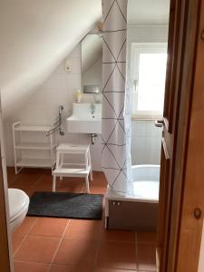 a bathroom with a toilet and a sink and a tub at Hahnhaus in Burscheid +22 photos