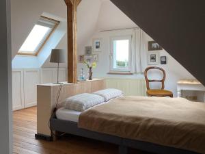 a bedroom with a bed and a chair at Hahnhaus in Burscheid