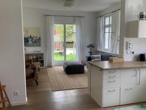 a kitchen with a table and a living room at Hahnhaus in Burscheid