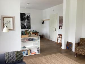 a living room with a book shelf and a chair at Hahnhaus in Burscheid