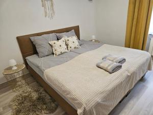 a bed with two pillows on it in a bedroom at Apartament Wiejska Sielanka in Ryn