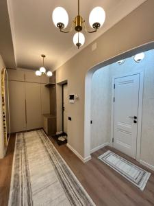 a hallway with a white door and a rug at Lola in Osh