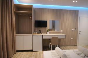 a kitchen with a counter and a desk in a room at Klea Rooms in Himare
