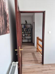 a hallway with a door and a book shelf at Fay-home in Odorheiu Secuiesc