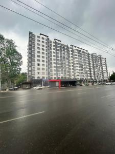 a large apartment building on the side of a street at Lola in Osh