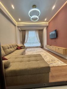 a living room with a couch and a flat screen tv at Lola in Osh