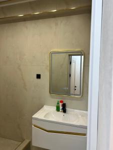 a bathroom with a sink and a mirror at Lola in Osh +5 photos