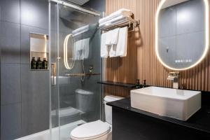 a bathroom with a toilet and a sink and a shower at The Tide's Out in Parksville