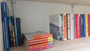 a bunch of books sitting on a shelf at Yr Hen Stabl - The Old Stable in Llangerniew