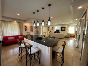 a kitchen and living room with a counter and chairs at VillaBelek in Belek