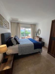 a bedroom with a bed and a large window at VillaBelek in Belek +30 photos