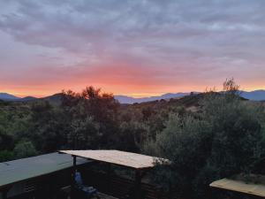 a view of the sunset from the roof of a house at Agriturismo Punta Su Cunventu in Narcao