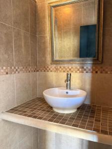 a bathroom with a sink and a mirror at HotelJosefadeMaria in Izamal +14 photos
