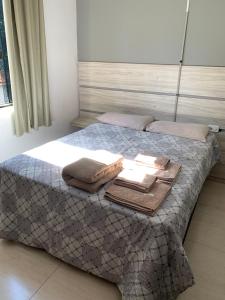 a bedroom with a bed with a tray of food on it at Hotel Airton in Ivaiporã
