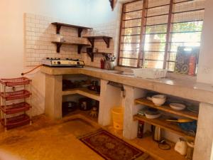 a kitchen with a counter top in a room at Villa Milu in Jambiani +3 photos