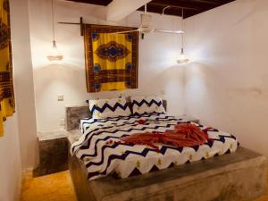 a bedroom with a bed in a room at Villa Milu in Jambiani