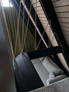 a staircase with a swing in a room at A frame Miška in Nána