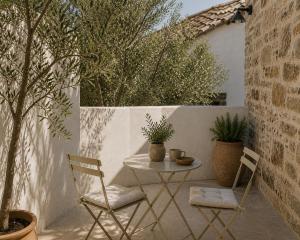 a patio with a table and two chairs at Palokastro House Quiet Village Stay with Terrace in Samos