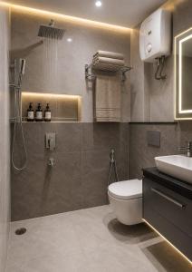 a bathroom with a toilet and a sink at Hotel GRAN-SOL Near DELHI Airport in New Delhi +18 photos