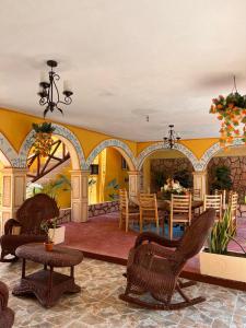 a room with chairs and a table and a dining room at HotelJosefadeMaria in Izamal