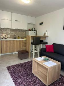 a living room with a couch and a table at Midpoint in Kotor