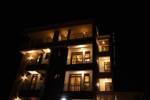 a night view of a building with lights at Travellers Palace Hotel in Kampala +6 photos