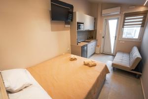 a small bedroom with a bed and a kitchen at Mediterranean Studio Halkidiki in Nea Kallikrateia
