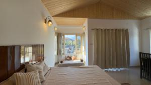 a bedroom with a large bed and a window at Sixtofifty Stays in Dharmsāla
