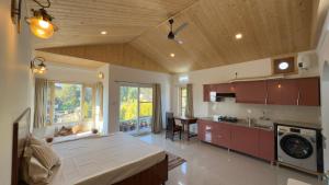 a large kitchen with a large bed in a room at Sixtofifty Stays in Dharmsāla