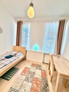 a bedroom with a bed and a dining room table at FAVORIT-ROOMS , direkt Metro connection U1 to Centralstation-Airport and City-Center in Vienna