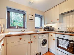 a kitchen with a washing machine and a sink at 1 Bed in Isle Of Arran oc-ca272 in Pirnmill